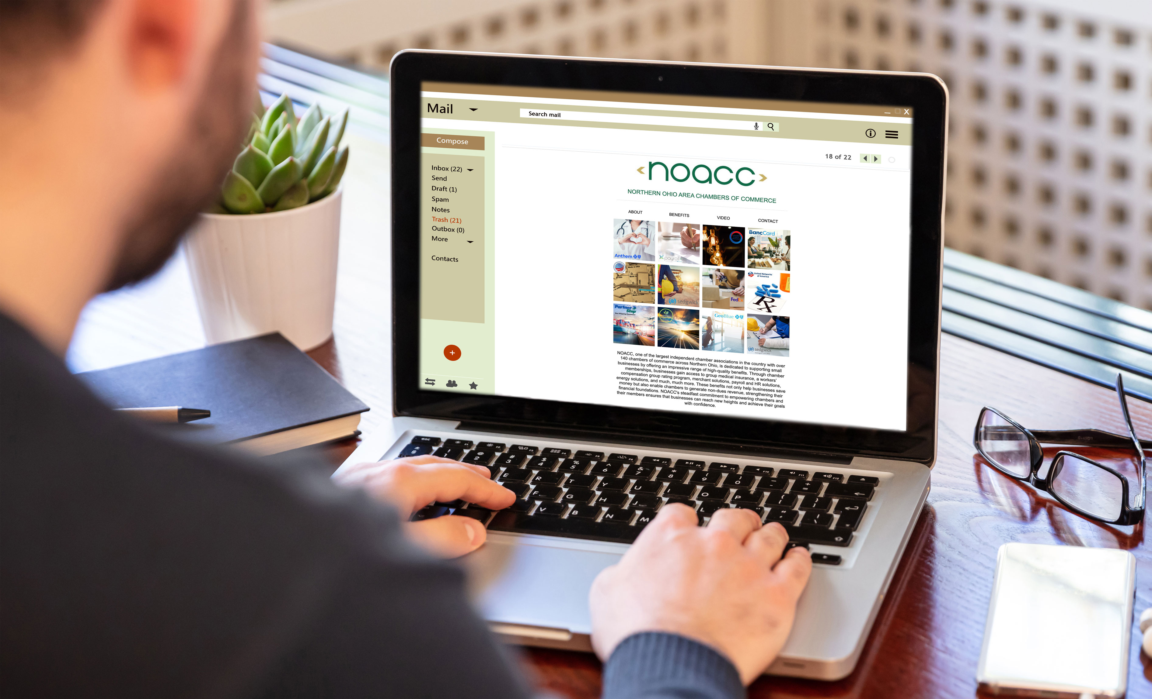 Looking over the shoulder of a man on a laptop viewing a NOACC email Looking over the shoulder of a man on a laptop viewing a NOACC email